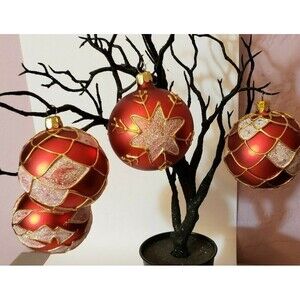 Red Christmas Ornaments with gold piping around the designs that are in Silver